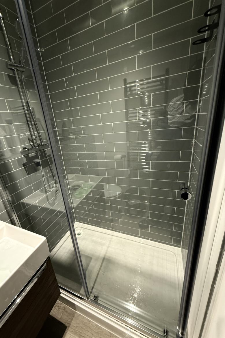 The same shower screen glass after professional cleaning by Cadence Clean