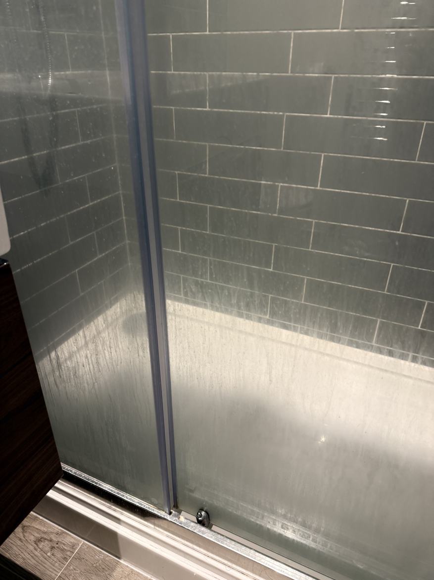 A shower screen glass before cleaning by Cadence Clean in Derby