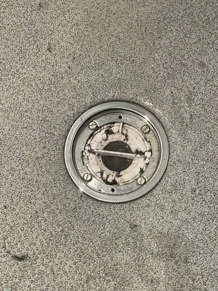 A shower drain before cleaning by Cadence Clean in Derby